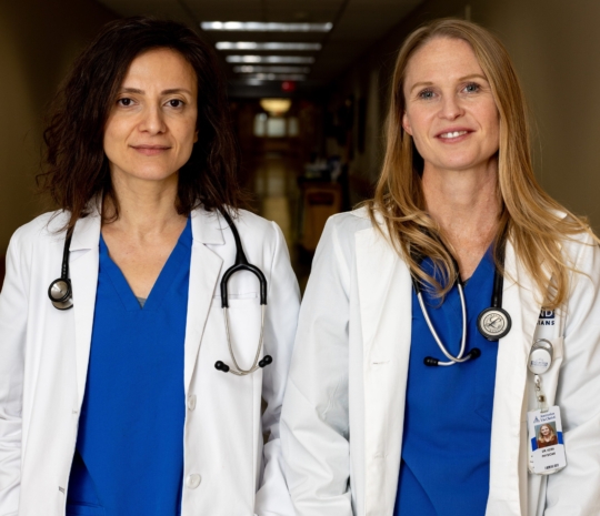 Two physicians in hospital hallway